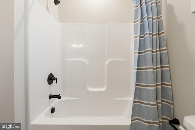 bathroom with shower / tub combo and toilet