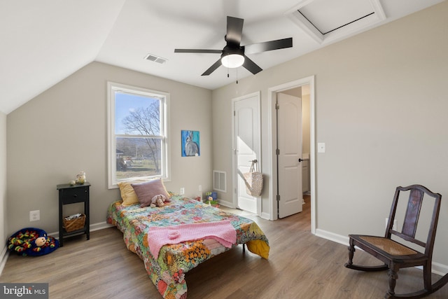 bedroom with lofted ceiling, ceiling fan, and light wood-type flooring