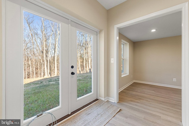 doorway to outside with light wood-type flooring