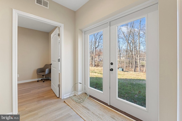 doorway to outside with french doors, light hardwood / wood-style flooring, and a wealth of natural light