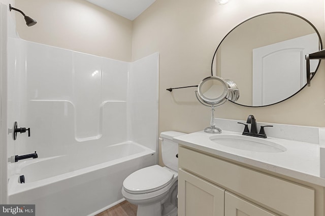 full bathroom with toilet, hardwood / wood-style flooring, bathing tub / shower combination, and vanity