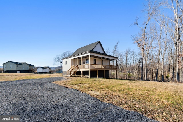 view of front of home with a porch and a front lawn