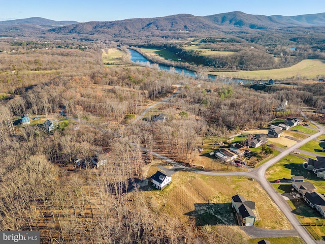 birds eye view of property with a water and mountain view