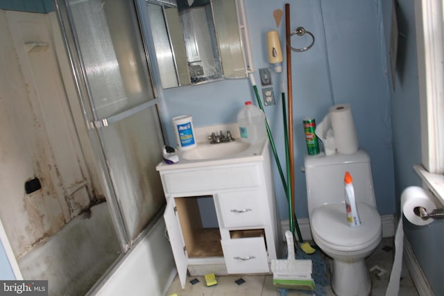 full bathroom featuring tile patterned floors, vanity, toilet, and shower / bath combination with glass door