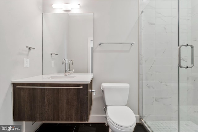 bathroom with tile patterned flooring, vanity, toilet, and a shower with shower door