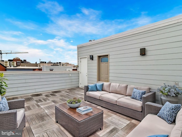 wooden terrace with outdoor lounge area