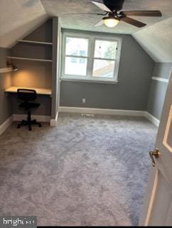 additional living space featuring carpet flooring, ceiling fan, built in desk, and lofted ceiling