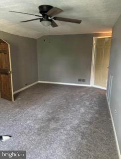 carpeted spare room featuring ceiling fan