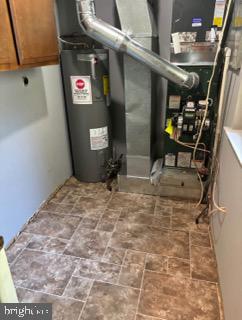 utility room featuring electric water heater