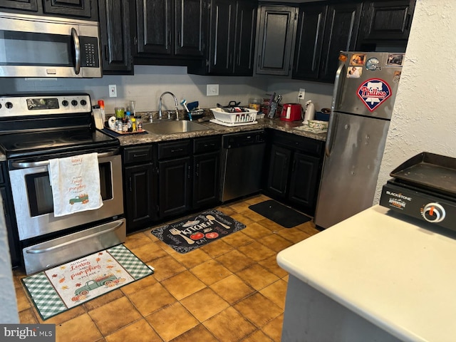 kitchen featuring sink, light tile patterned floors, and appliances with stainless steel finishes