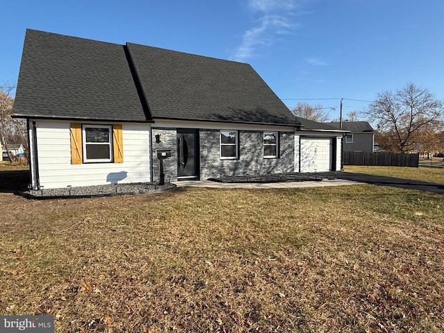 view of front of property featuring a garage and a front lawn