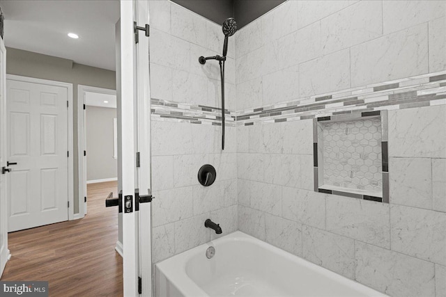 bathroom featuring hardwood / wood-style floors and tiled shower / bath