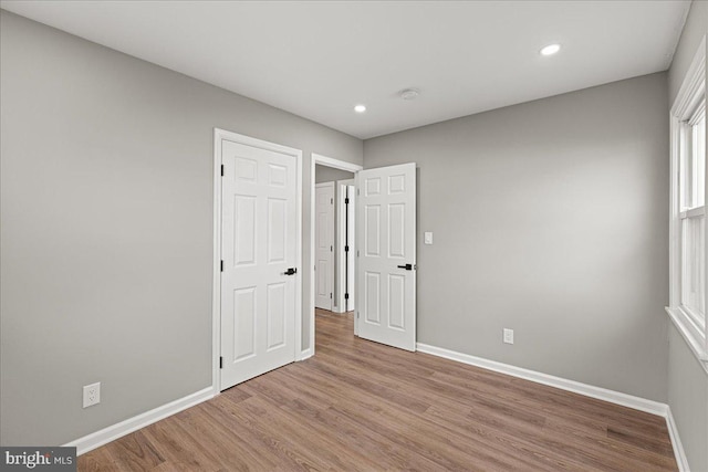 unfurnished bedroom featuring light wood-type flooring