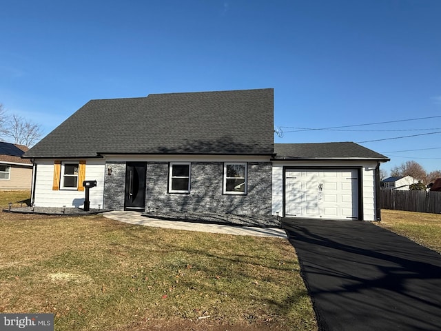 view of front of property with a front yard and a garage