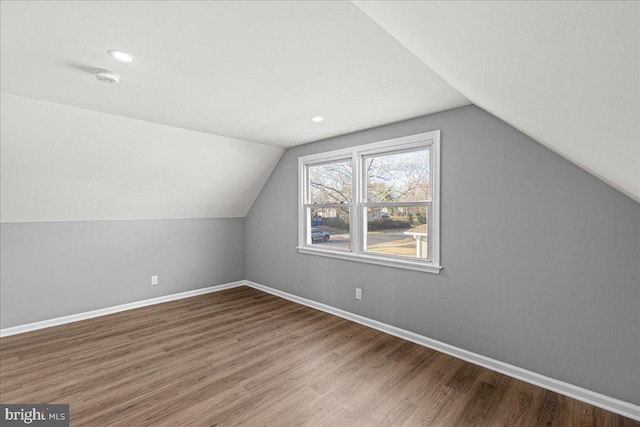 bonus room with wood-type flooring and lofted ceiling