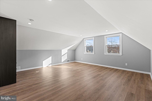 additional living space with lofted ceiling and dark hardwood / wood-style floors