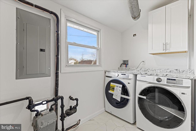 laundry room featuring electric panel, cabinets, and independent washer and dryer