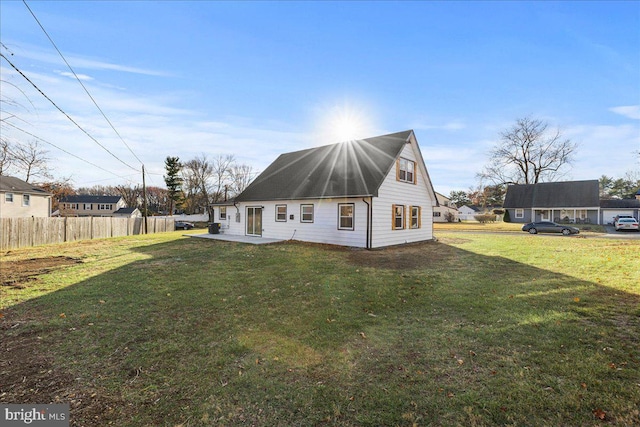 back of house with a yard and a patio