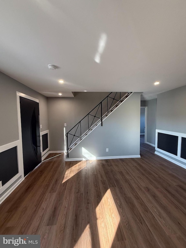 unfurnished living room with dark hardwood / wood-style floors