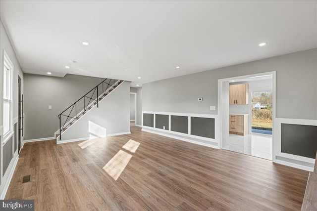 unfurnished living room with hardwood / wood-style flooring