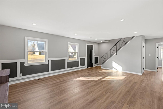 unfurnished living room with wood-type flooring