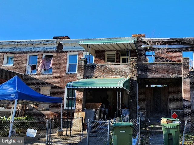 3706 Towanda Ave, Baltimore, MD 21215 - view of front of home with brick siding, a gate, and a fenced front yard