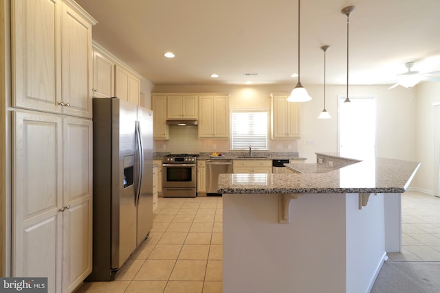 kitchen with appliances with stainless steel finishes, ceiling fan, sink, light tile patterned floors, and hanging light fixtures