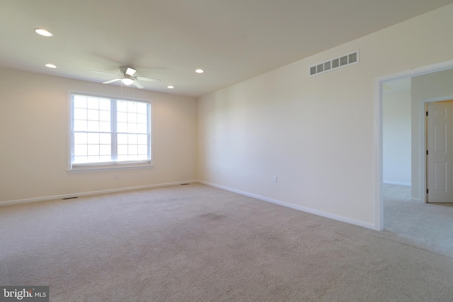 unfurnished room with light carpet and ceiling fan