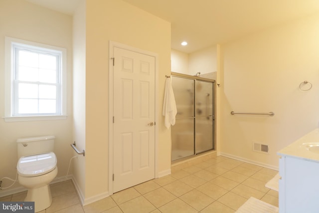 bathroom featuring toilet, vanity, tile patterned floors, and walk in shower