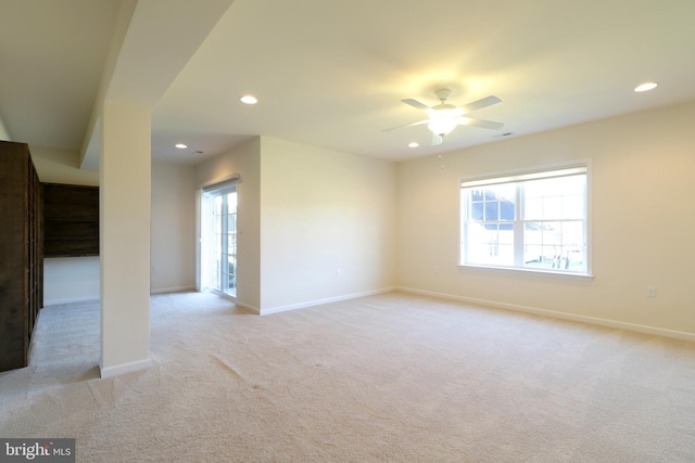 carpeted empty room featuring ceiling fan