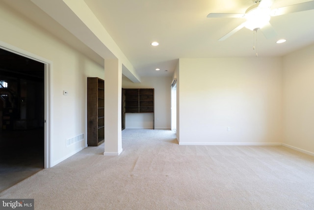 unfurnished room with ceiling fan and light colored carpet