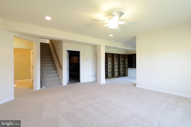 carpeted empty room featuring ceiling fan