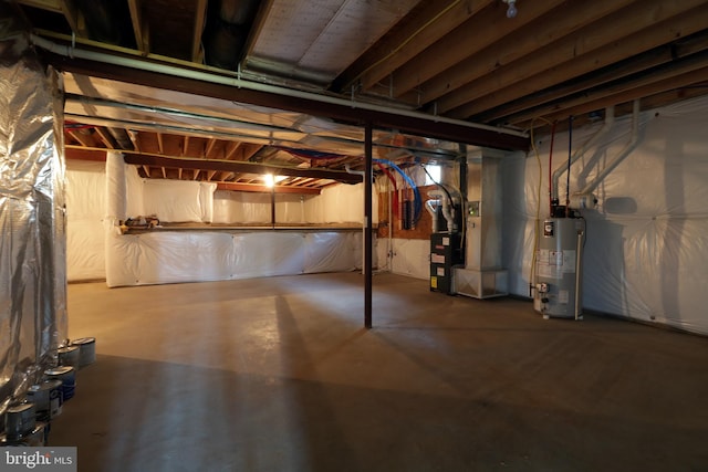 basement featuring heating unit and water heater