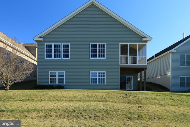 rear view of property with a yard