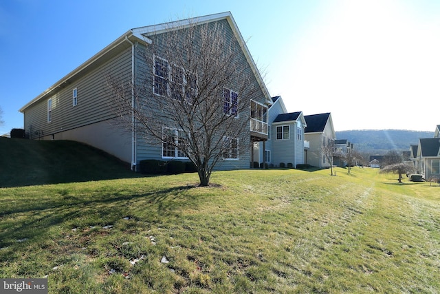 view of side of home with a lawn