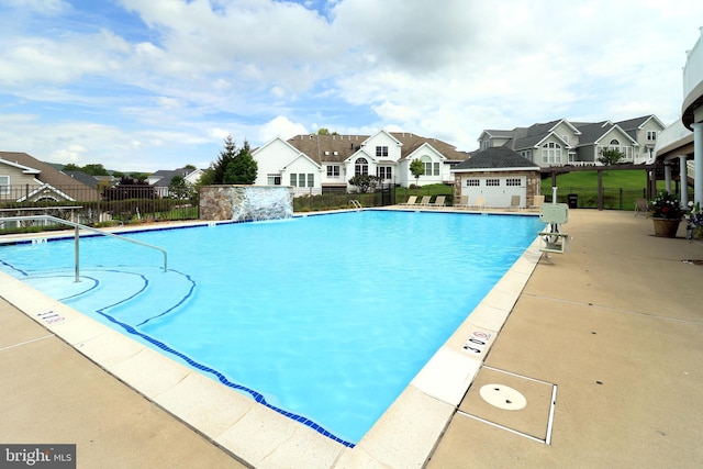 view of pool with pool water feature and a patio