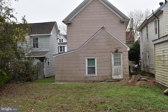 back of property with a lawn