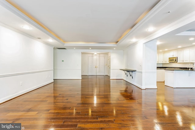 7902 Brynmor Ct Unit 201, Pikesville, MD 21208 - unfurnished living room featuring a raised ceiling, hardwood / wood-style flooring, ornamental molding, baseboards, and recessed lighting