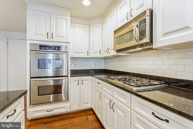 7902 Brynmor Ct Unit 201, Pikesville, MD 21208 - kitchen with stainless steel appliances, white cabinets, dark stone countertops, dark wood finished floors, and tasteful backsplash