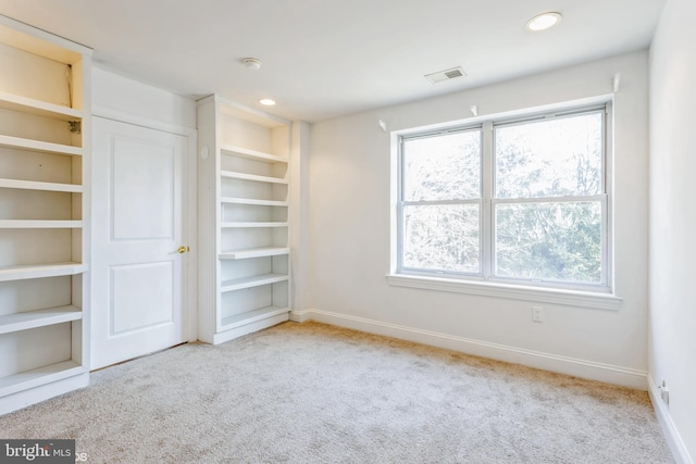 interior space featuring light carpet