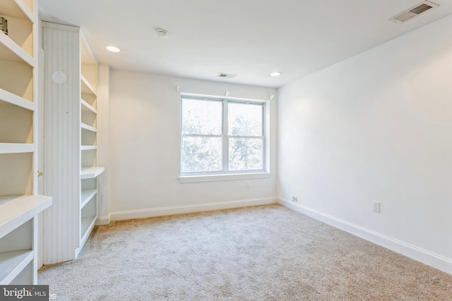 unfurnished room with light carpet