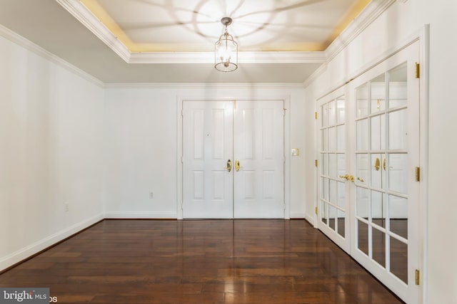 entryway with crown molding and dark wood-type flooring