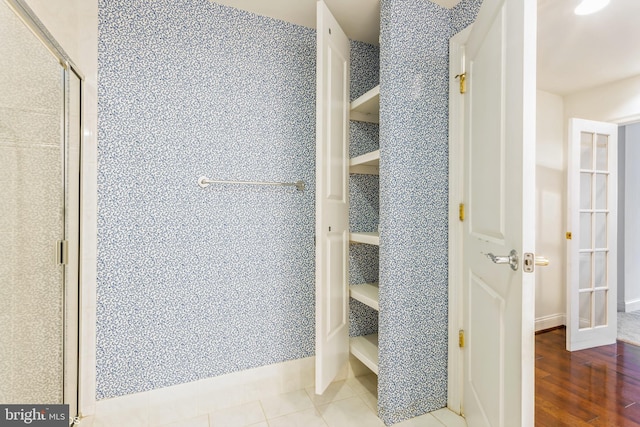 bathroom featuring hardwood / wood-style floors and walk in shower