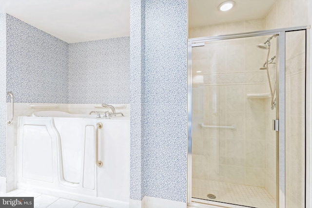 bathroom with tile patterned floors and a shower with door