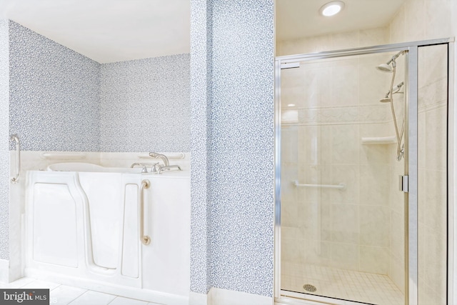 7902 Brynmor Ct Unit 201, Pikesville, MD 21208 - bathroom with a stall shower, a garden tub, and tile patterned floors