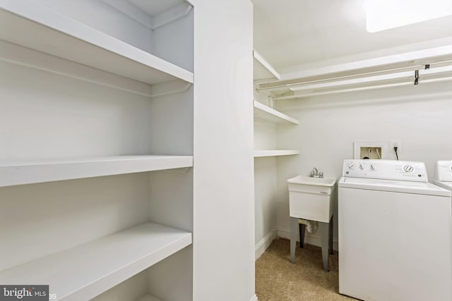 laundry room with light colored carpet and washing machine and clothes dryer