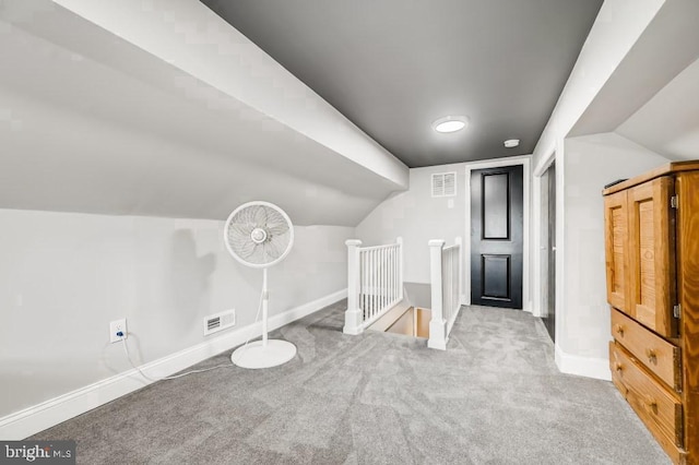 bonus room featuring light colored carpet and vaulted ceiling