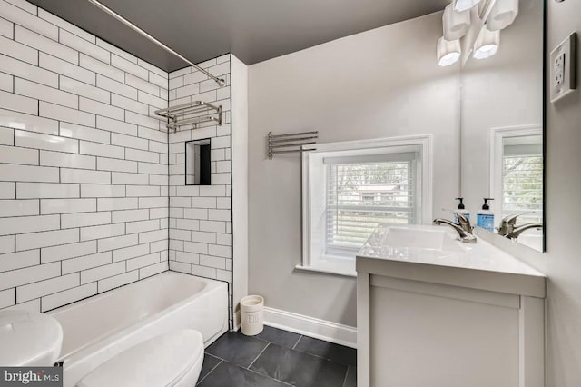 full bathroom with tile patterned floors, toilet, vanity, and tiled shower / bath