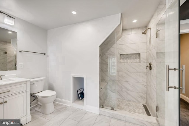 bathroom with vanity, toilet, and a shower with door