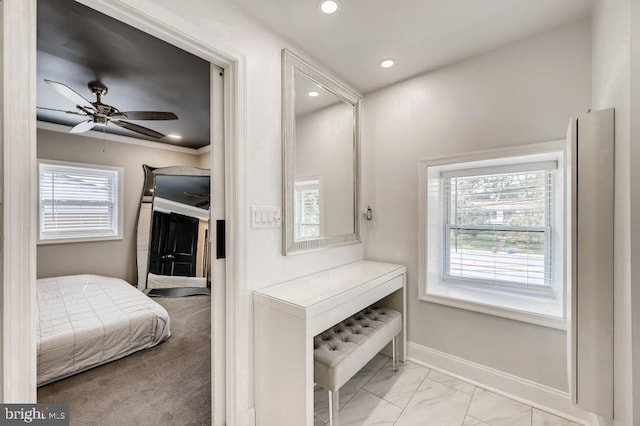 interior space with light carpet, multiple windows, crown molding, and ceiling fan